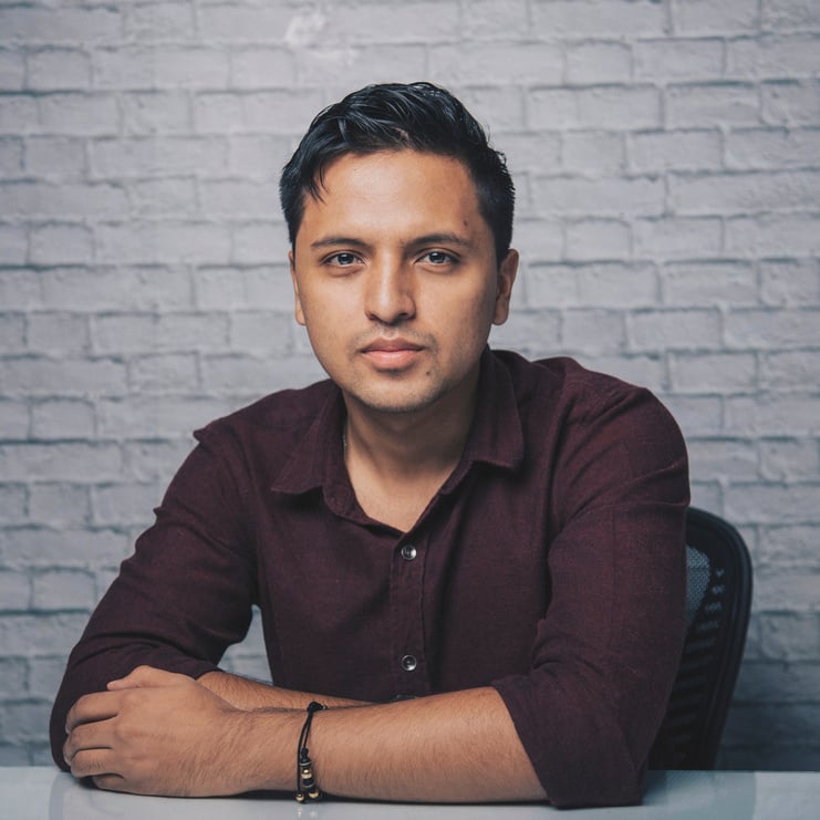 Serious ethnic man sitting at desk